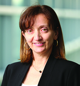 Headshot of a smiling woman with shoulder-length brown hair.