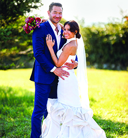 A bride and groom embrace