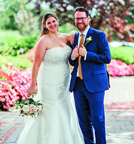 A bride and groom smile at the camera