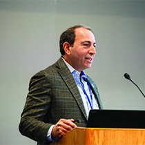 A man speaks at a podium