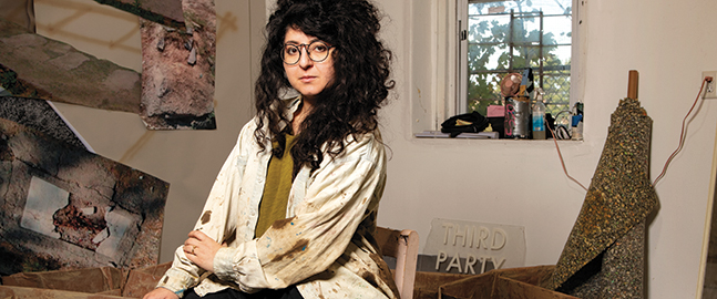 Photo portrait of Sheida Soleimani, seated in a studio space at her home in Providence, Rhode Island.