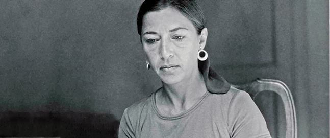 Photo of a young Ruth Bader Ginsburg seated in front of a typewriter.