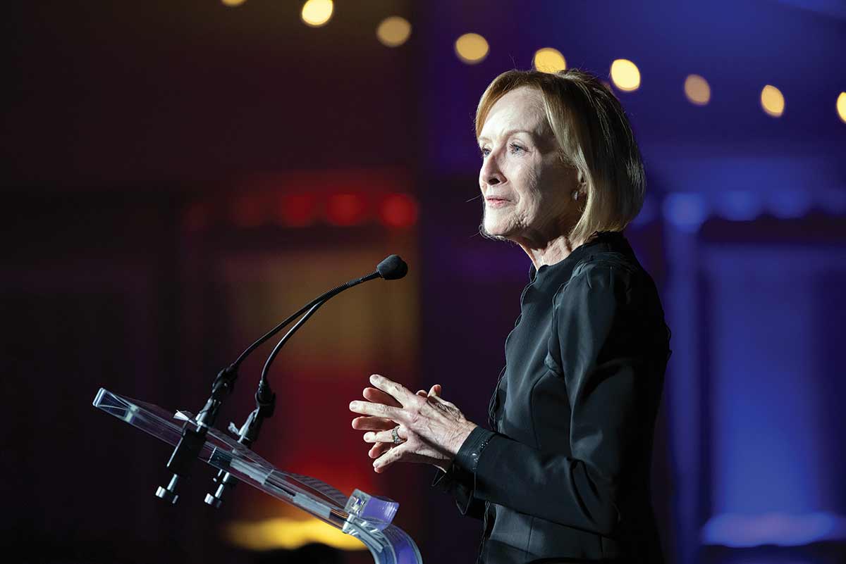 Judy Woodruff speaking at a podium