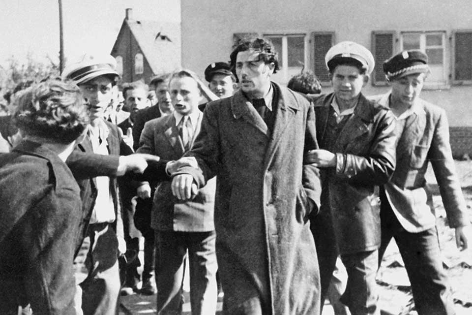 Jewish police at a displaced persons camp restrain a man