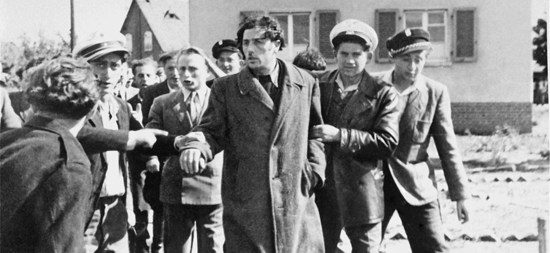 Jewish police at a displaced persons camp restrain a man