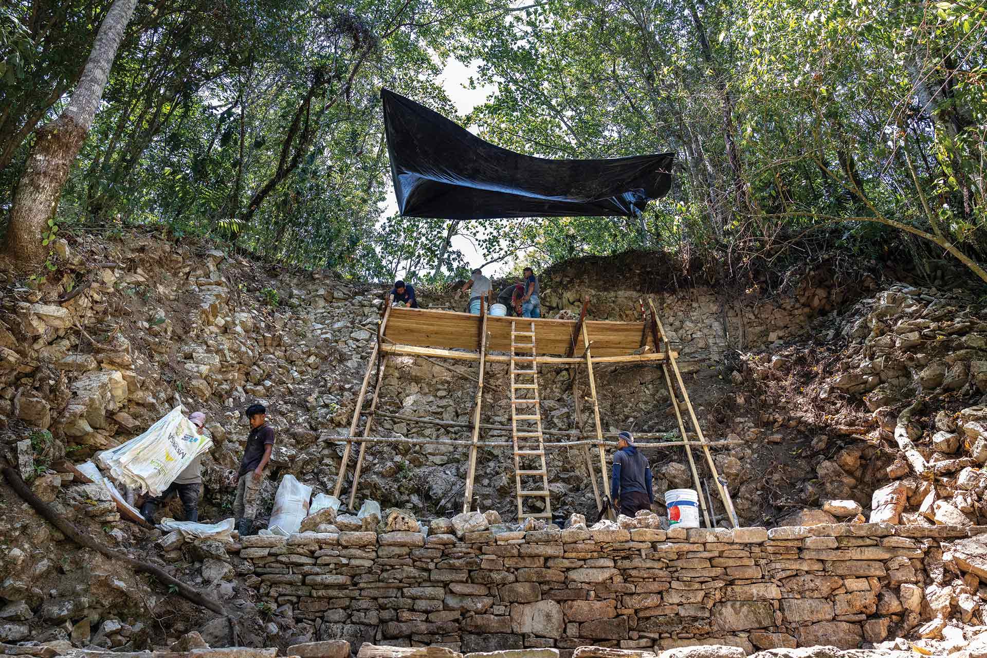 People on scaffolding work on the acropolis walls