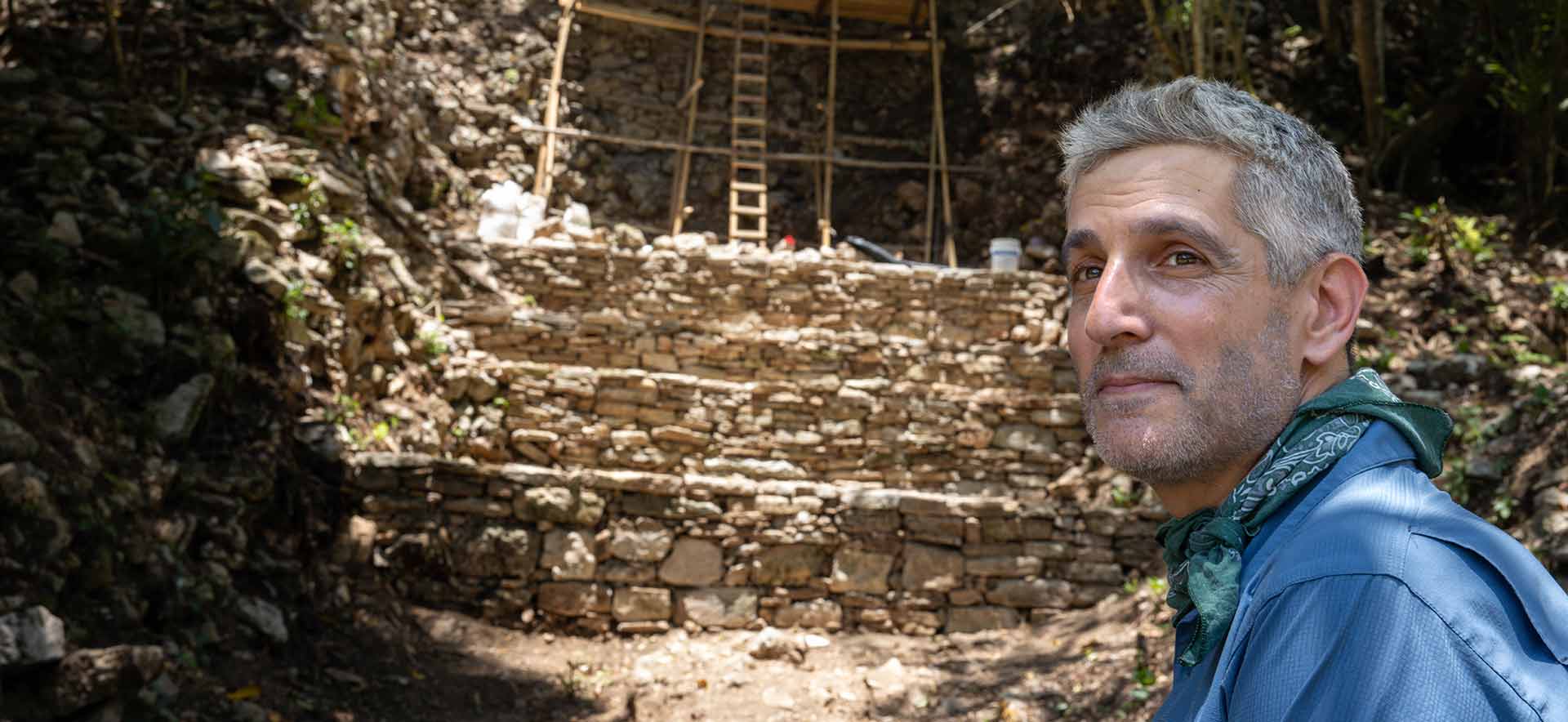 Charles Golden with the structure of the acropolis in the background