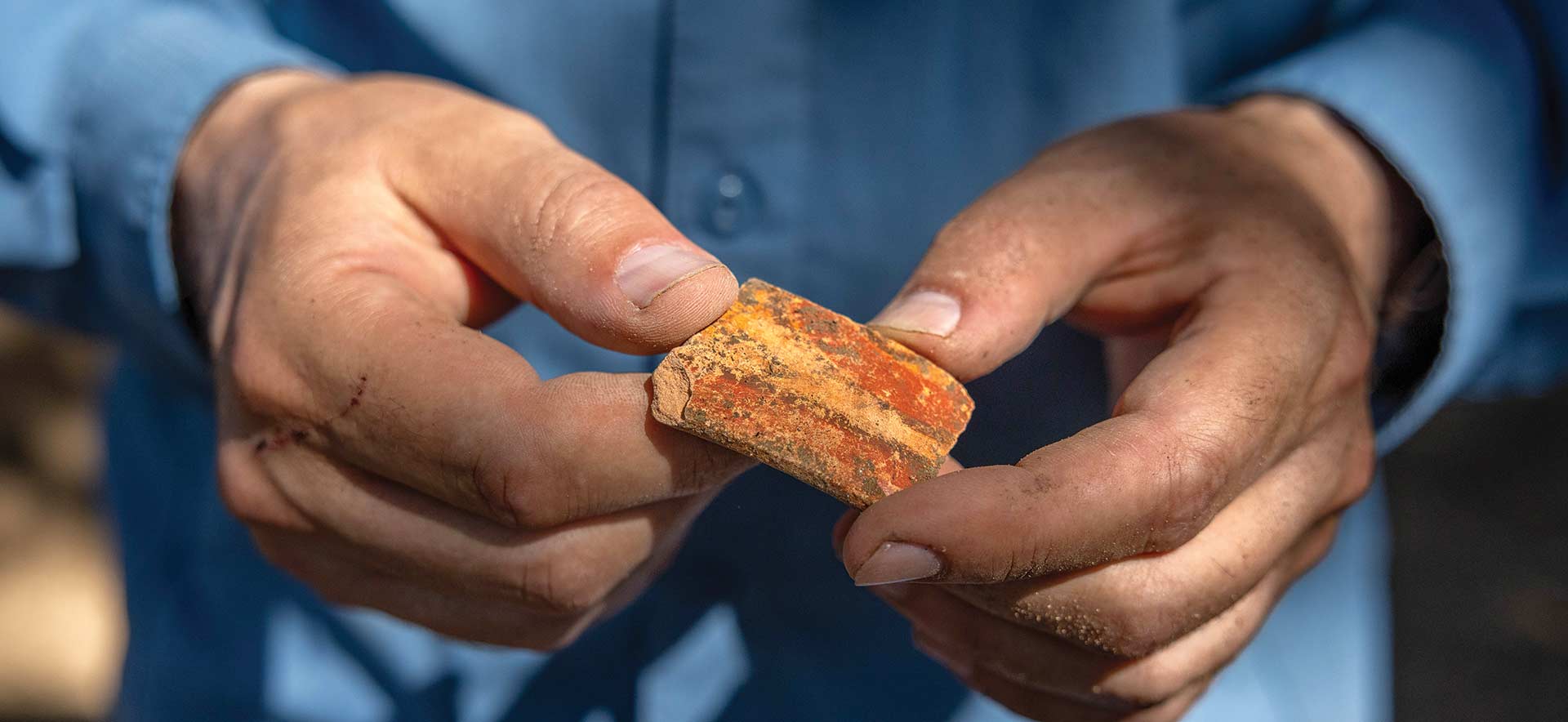 Closeup of hands holding an artifact