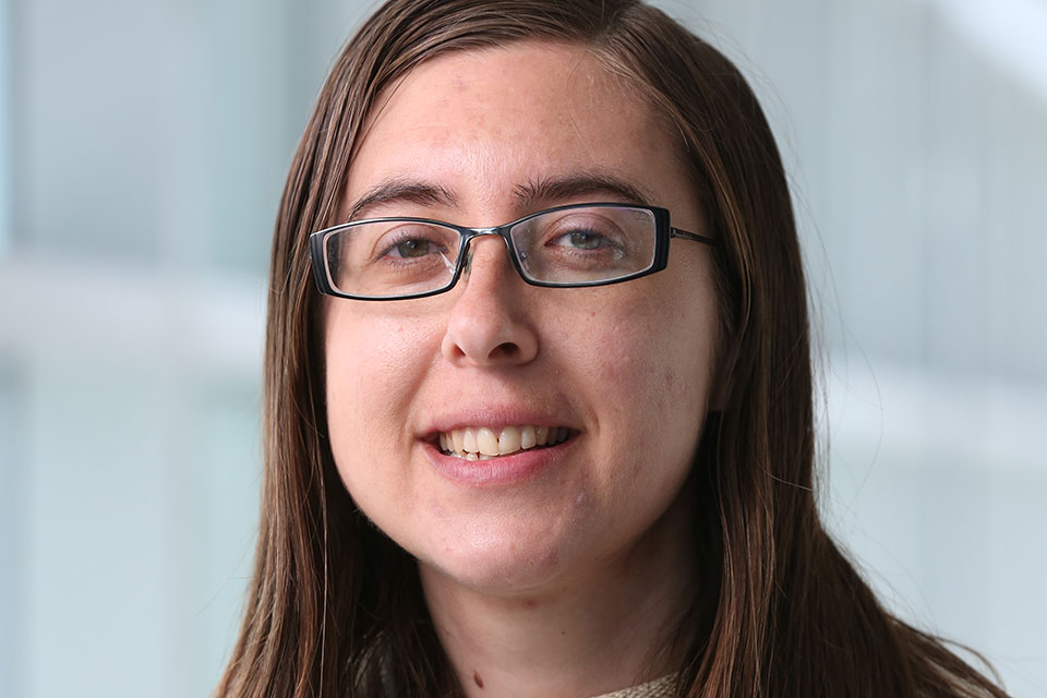 Hannah Snyder wearing glasses and smiling at the camera