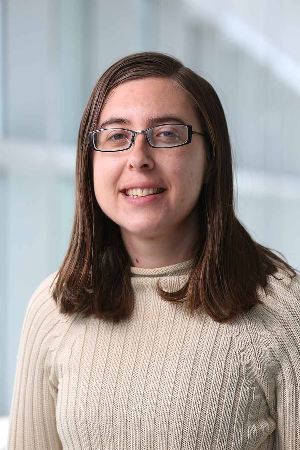 Hannah Snyder wearing glasses and smiling at the camera