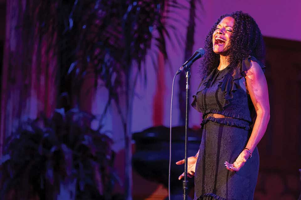 Audra McDonald singing on stage