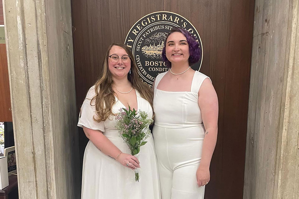 A married couple smiles together in Boston City Hall.