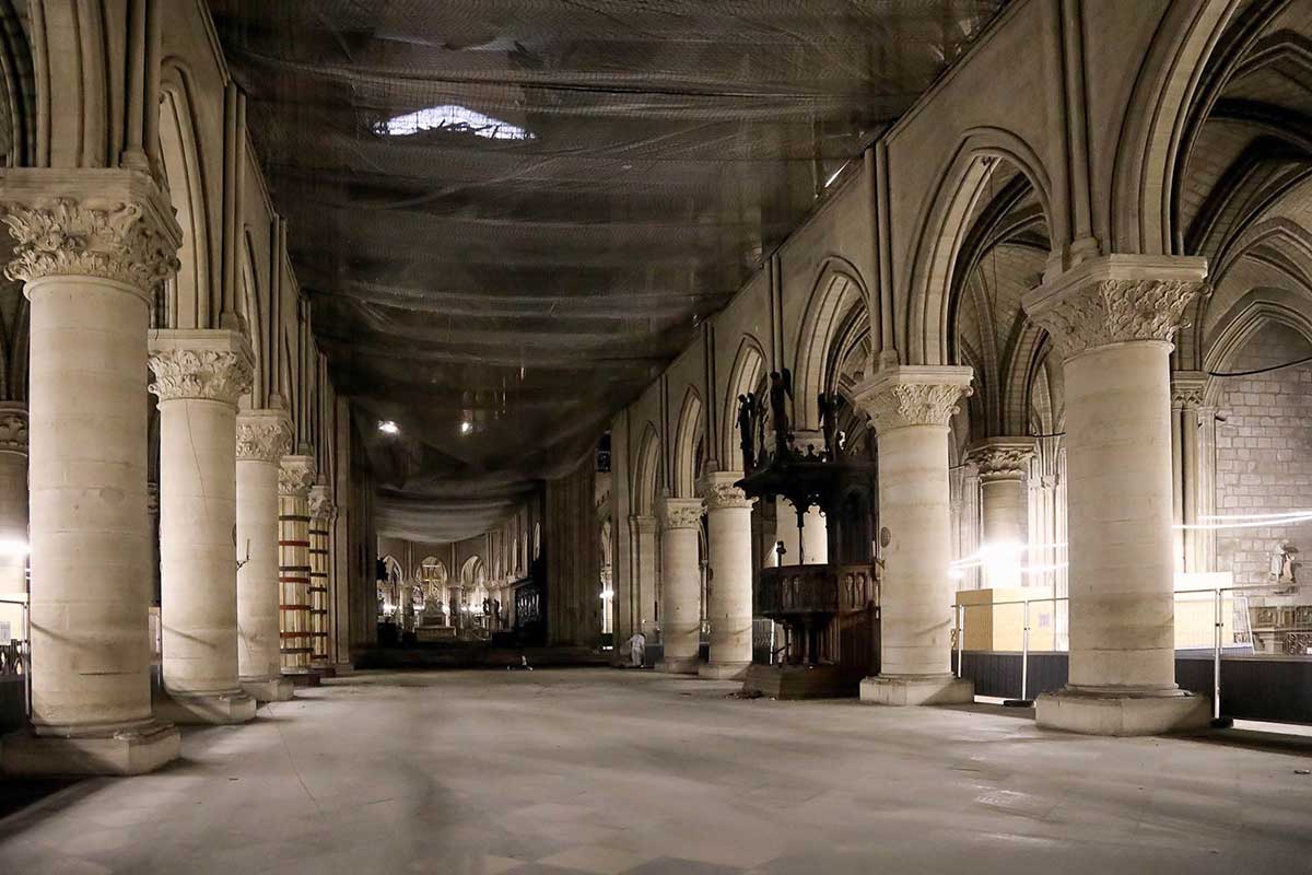 Looking down a hallway lined with columns, inside of Notre Dame
