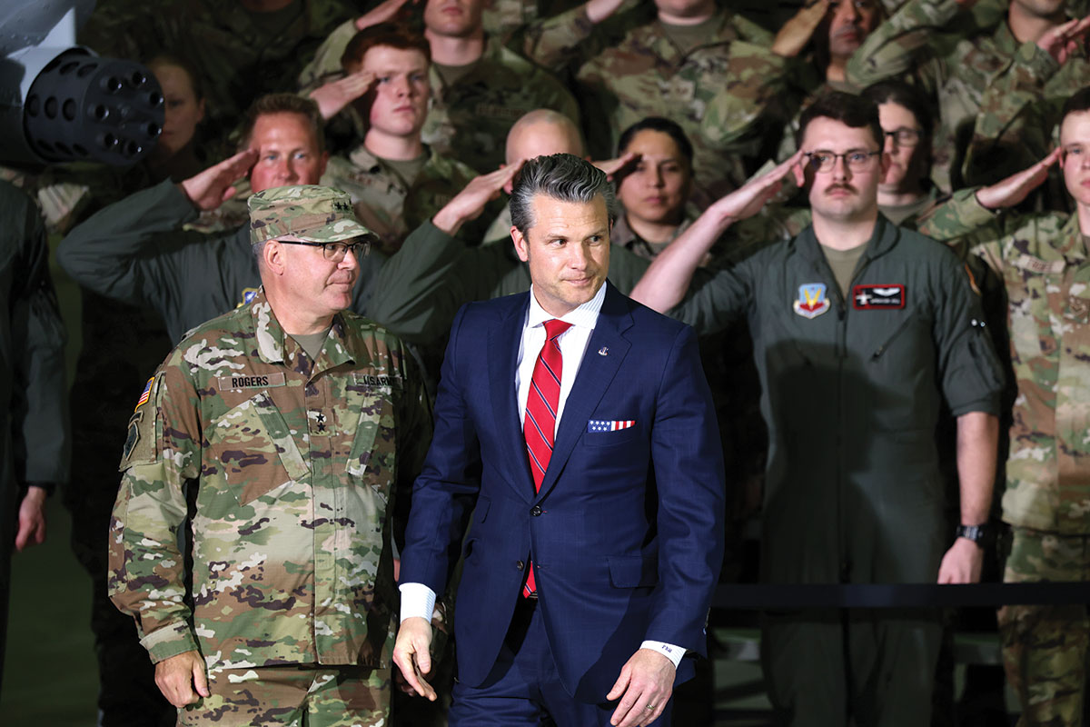 Defense secretary Pete Hegseth standing in front of a group of soldiers.