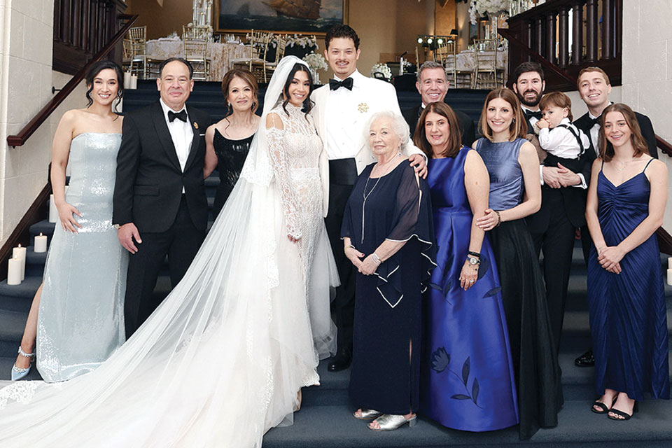 Natalie Cohen ’20 and Jonah Fischer ’18 stand with family on their wedding day.