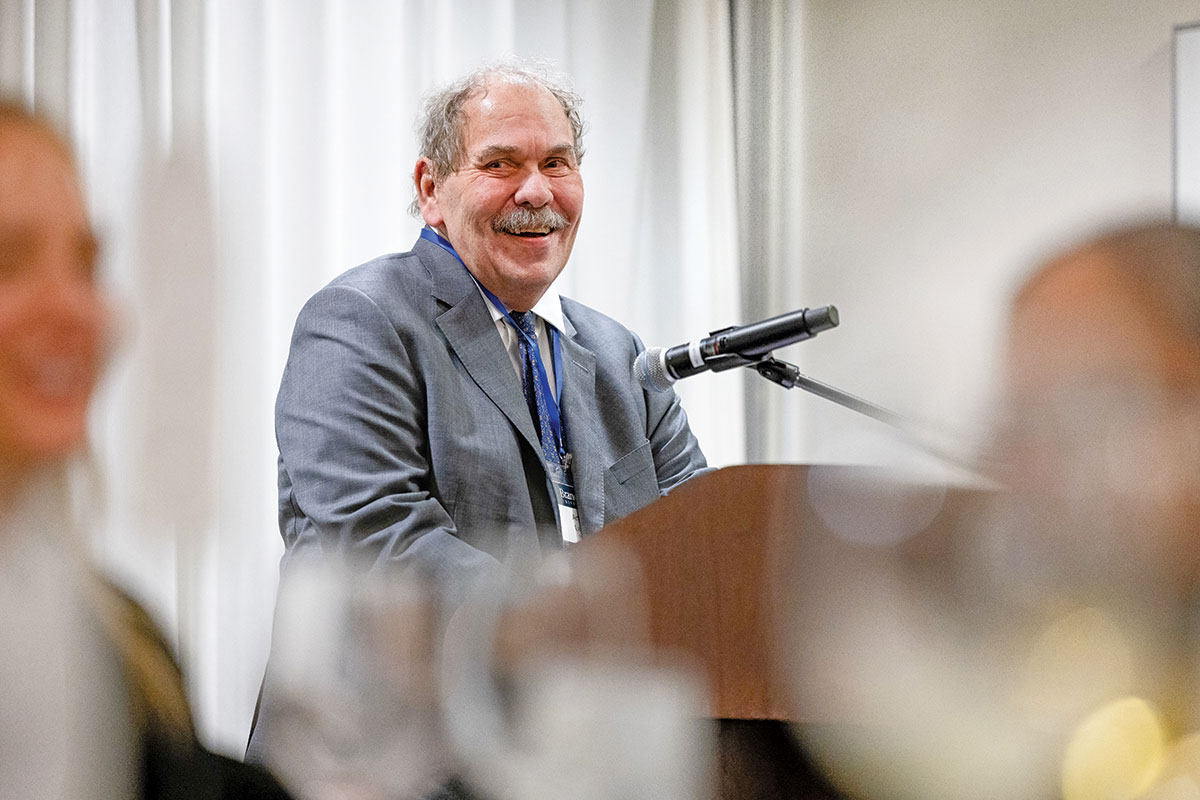 Arthur Levine smiling at a podium
