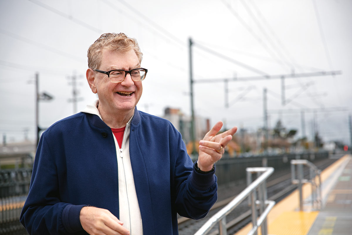 Dan Scheinman smiles with an outstretched hand