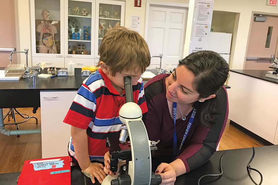 Danna Zeiger and her son looking through a microscope.