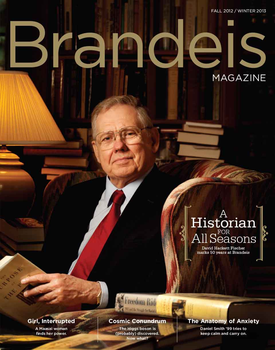 Fall 2012-Winter 2013 Brandeis Magazine cover with a photo of David Hackett Fischer sitting in a wingback chair, surrounded by books. There is text that reads “A Historian for All Seasons: David Hackett Fischer Marks 50 Years at Brandeis.”
