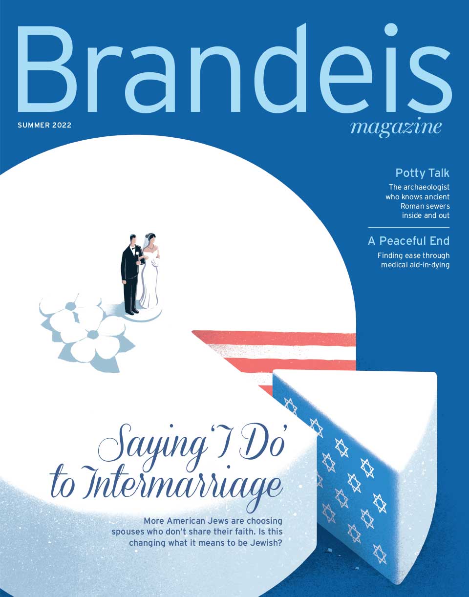 Summer 2022 Brandeis Magazine cover with an illustration of a wedding cake topped with groom and bride figurines; a slice is cut out, revealing red and white stripes on one side, white Stars of David against a blue background on the other. There is text that reads Saying 'I do' to Intermarriage.