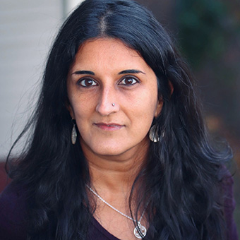 Dr. Ulka Anjaria in a purple shirt