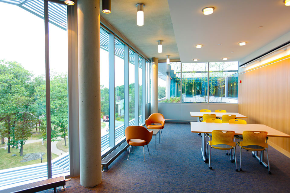 Tables and chairs in a brightly-lit sitting area of the Mandel Center.