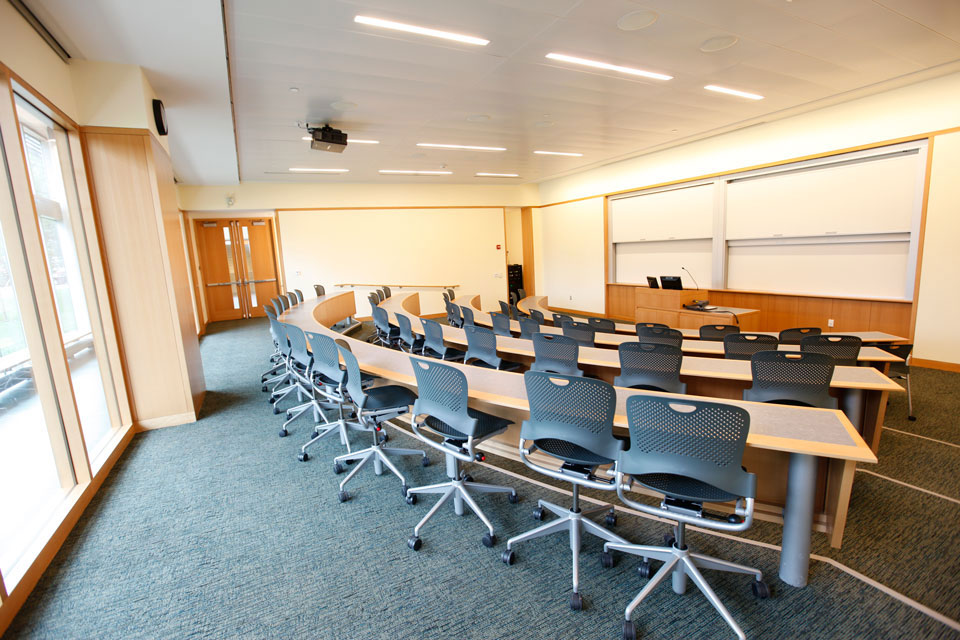 Brightly lit, empty lecture room.