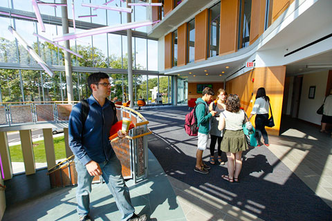 Students milling about in the sun lit Mandel Center.
