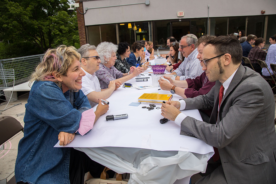 Participants talking across a long table together.