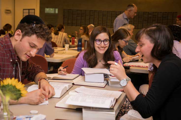 Three people discussing at a table