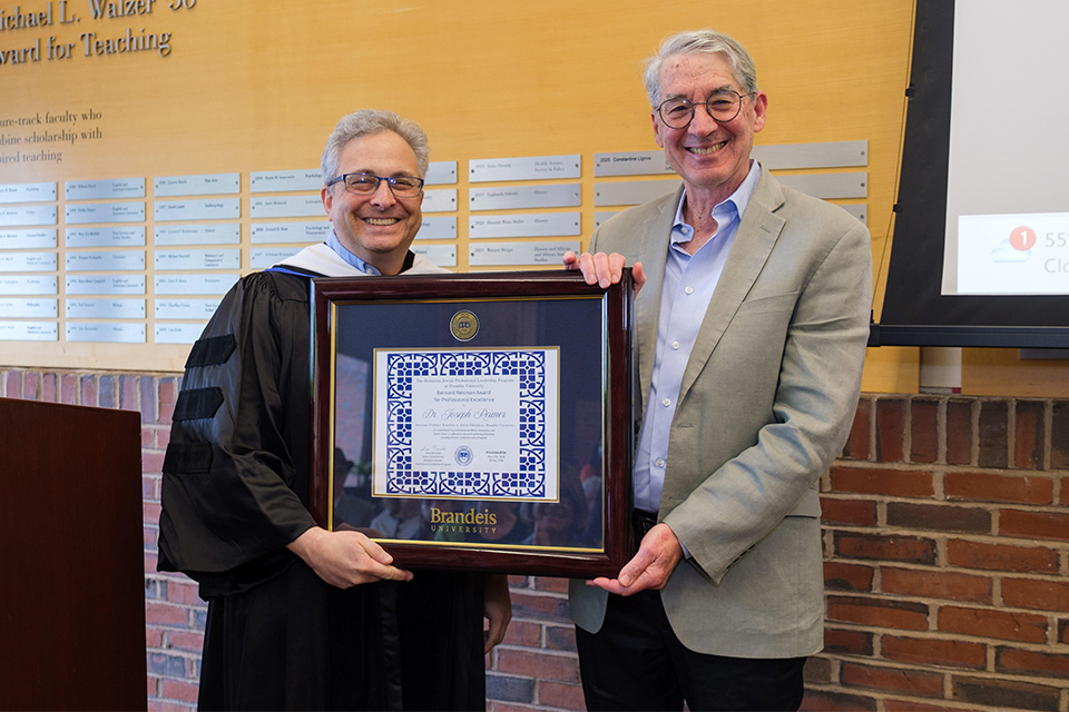 Jonathan Krasner and Joe Reimer together holding an award.