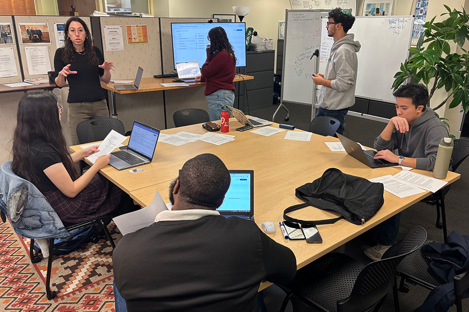 Scroll lab in action - Prof. Ziva Hassenfeld and Scroll Lab participants around a table in the lab.