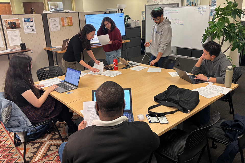 2025 SCRoLL Lab in action. Students around a table with Ziva Hassenfeld in SCRoLL Lab.