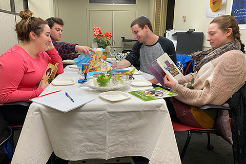 Group of students around a table at a Seder