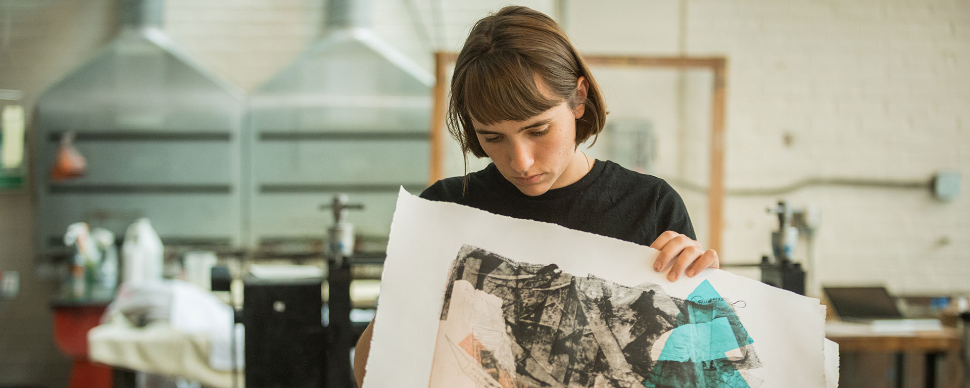 A student looks at art in a studio