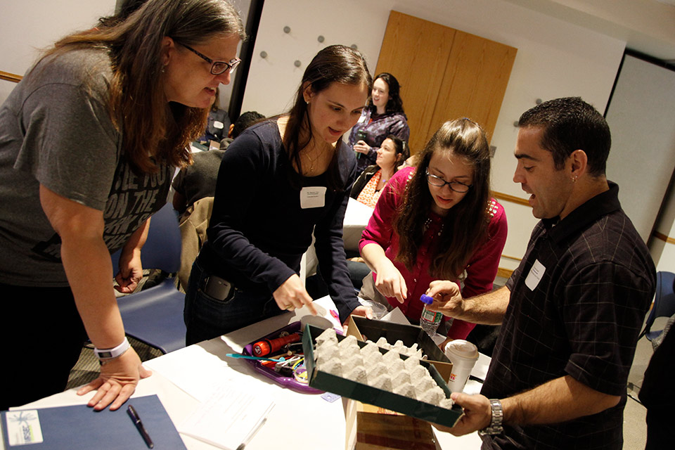 Small group working together with various materials