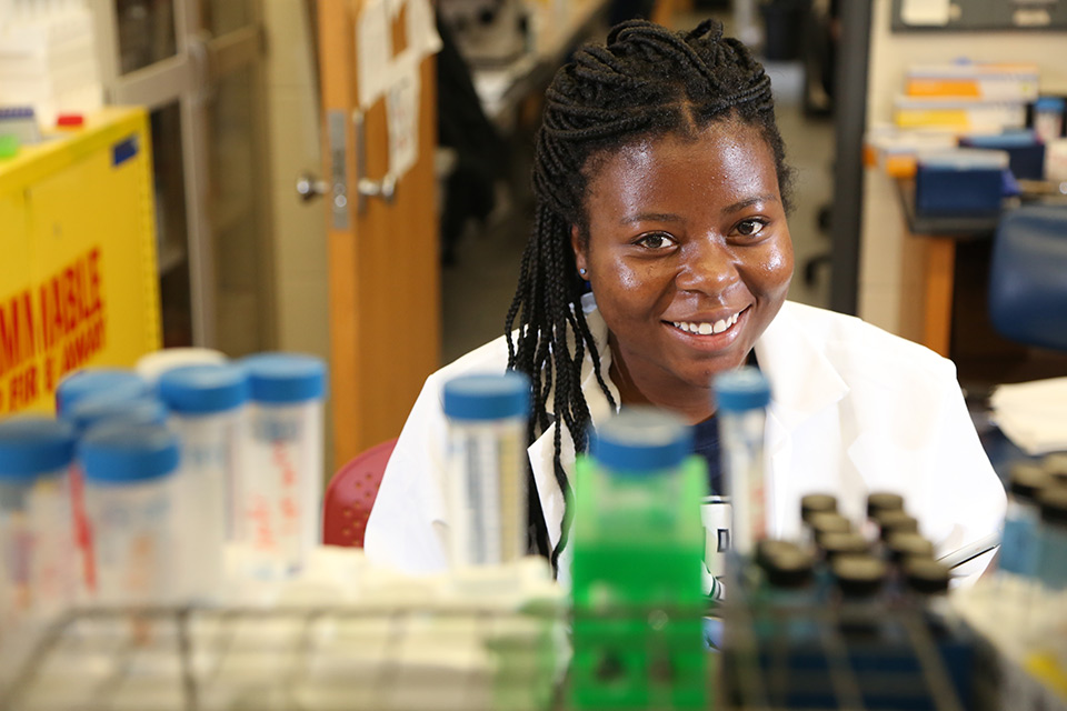 Student smiling in a science lab