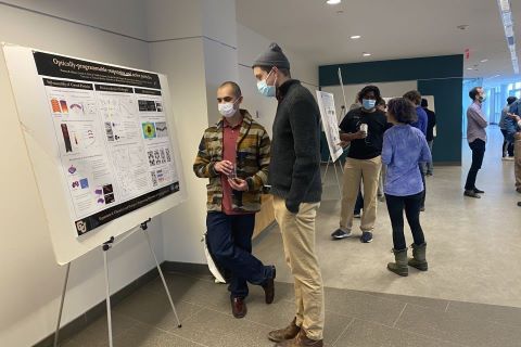 Retreat participants showcasing their poster
