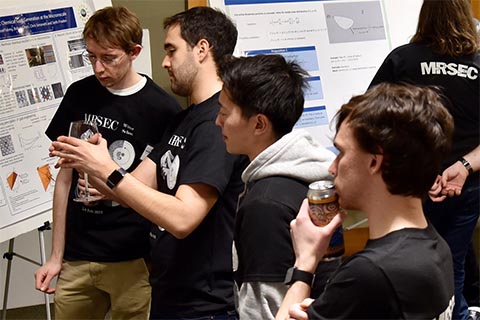 Several participants examining a poster.