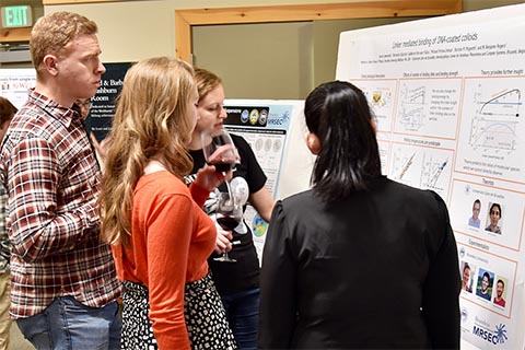 Four participants discussing a poster.