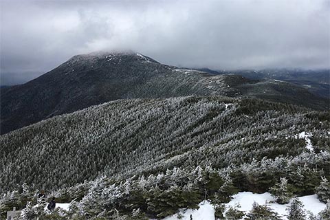 Panoramic vista of the mountains and a frozen lake from up above