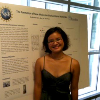 Kristine Chiu standing in front of her poster at the Brandeis symposium.