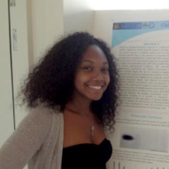 Shanice Graham standing in front of her poster at the Brandeis Symposium