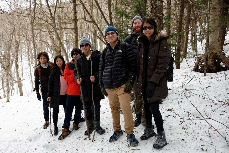 A group hiking in the woods in winter