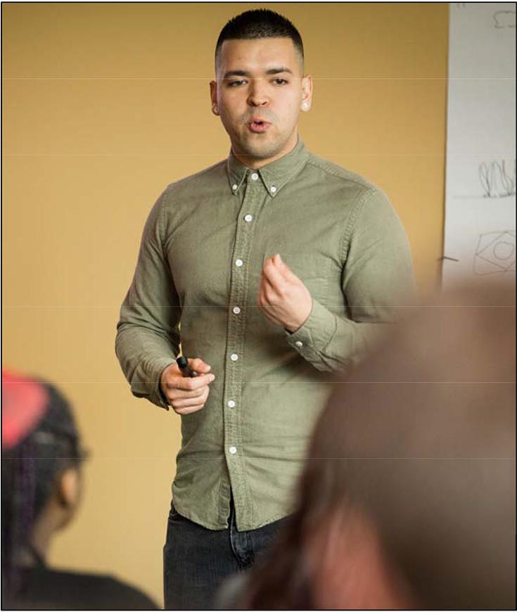 Scientist talking to a Waltham High School class on a field trip.