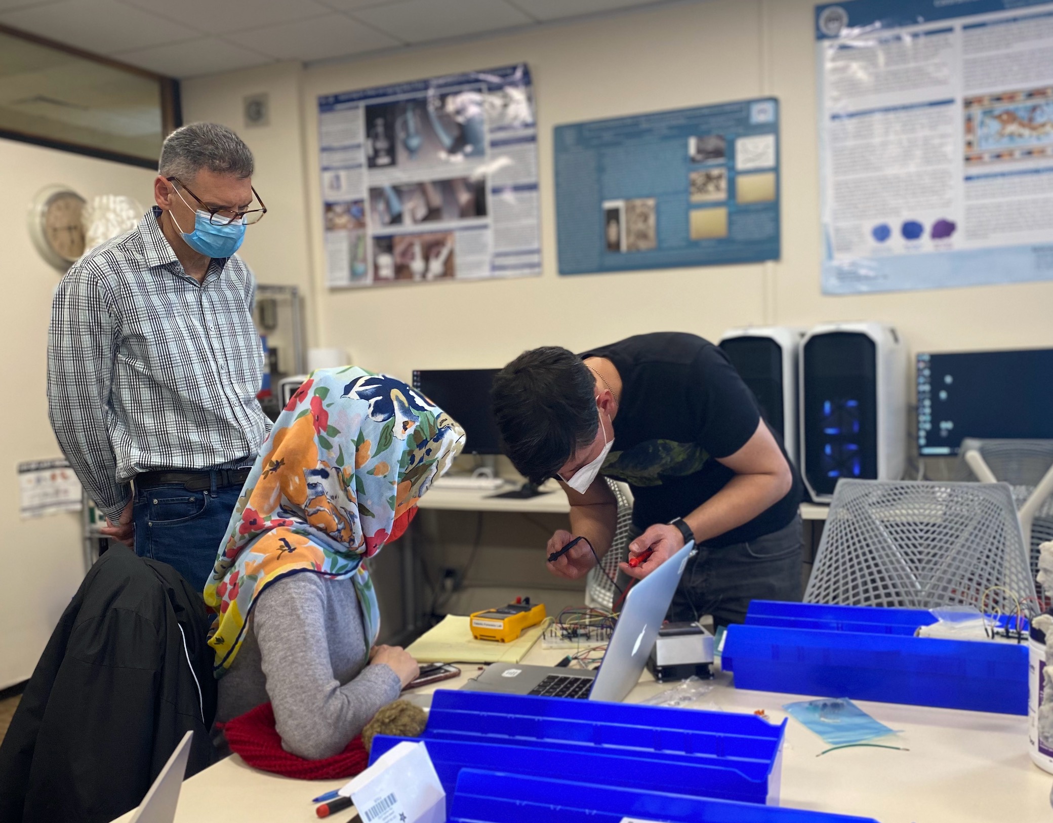 Seth Fraden watching participants work on electronics fabrication. 