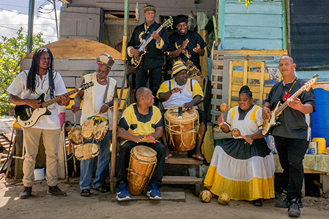 The members of the Garifuna Collective perform on an outdoor set of steps