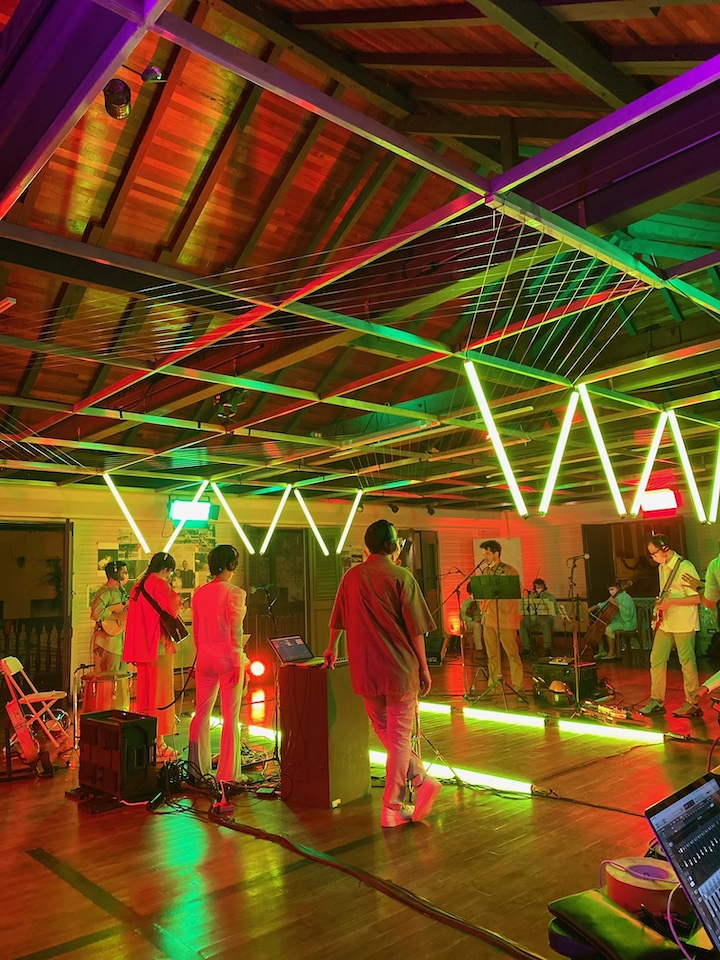 The members of Balún performing for the concert video shoot with various colored lights