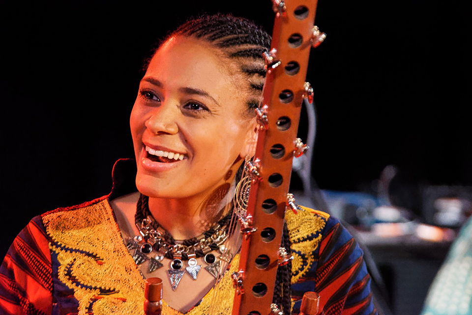 Sona Jobarteh smiles with her kora instrument