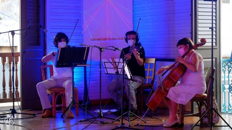 A trio of string musicians perform